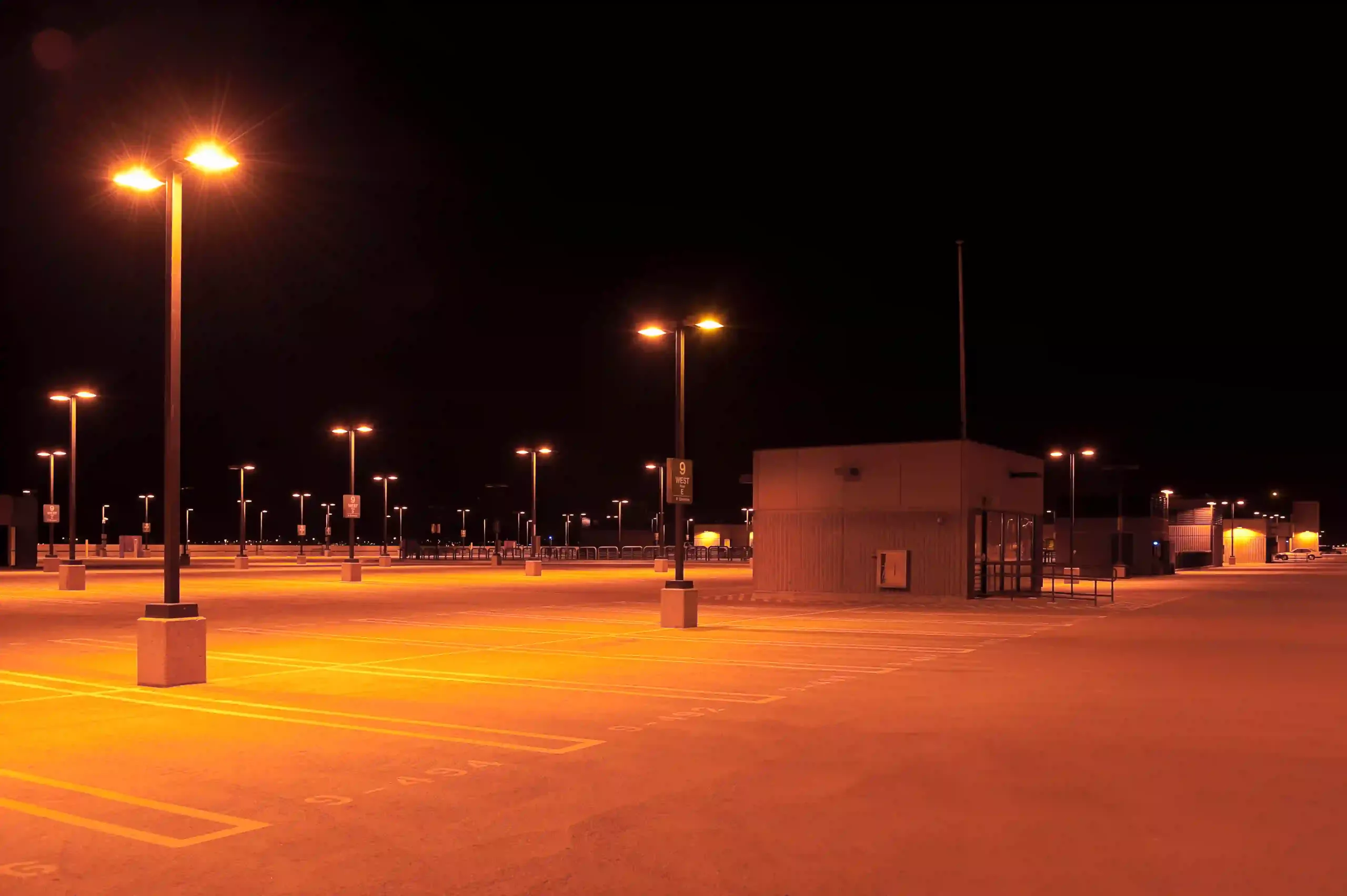 Empty Parking Lot With Street Lights At Night