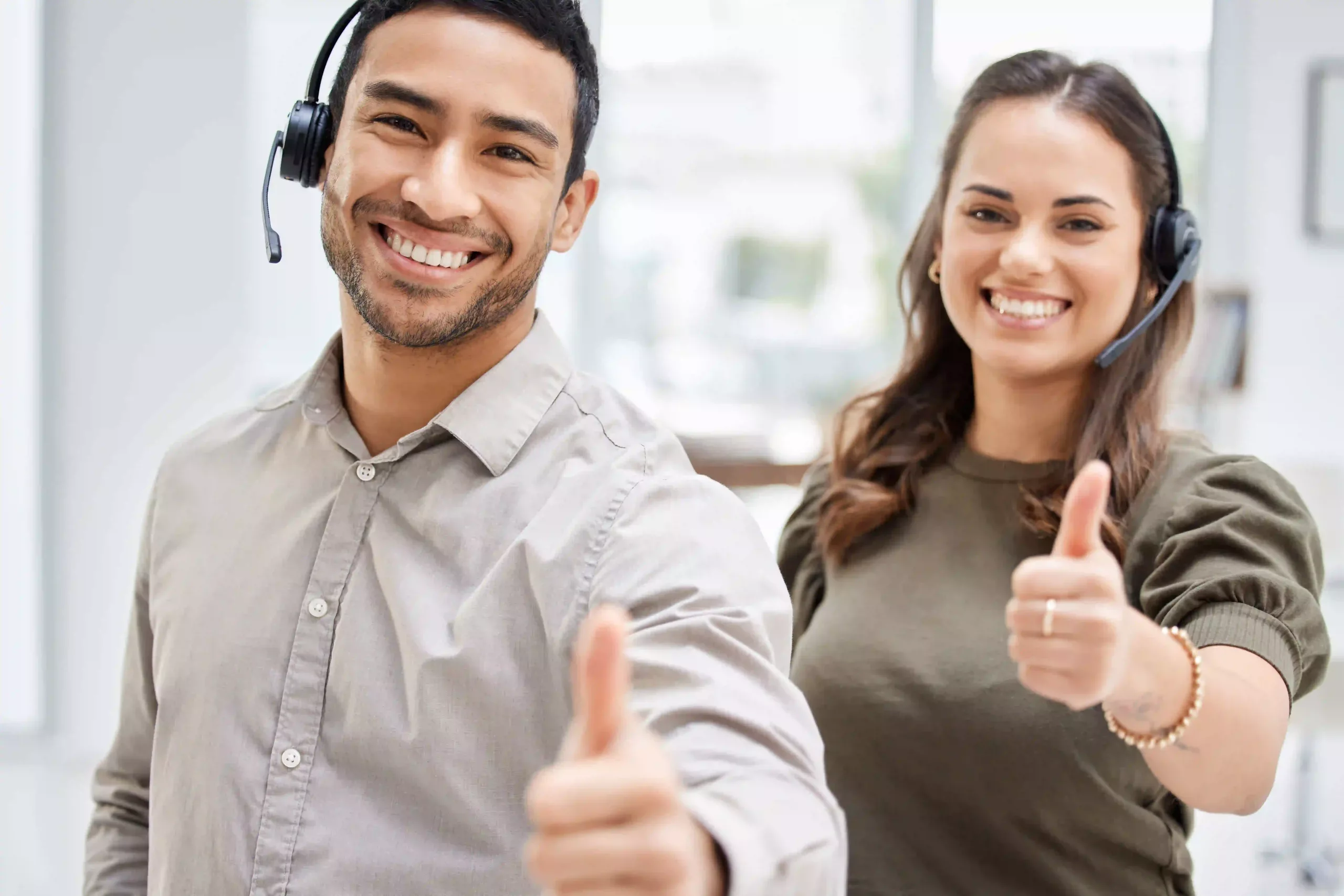 Cropped Portrait Of Two Young Call Center Agents Giving Thumbs Up While Standing In The Office,emphasizing The Manufacturer's Commitment To After Sales Support.