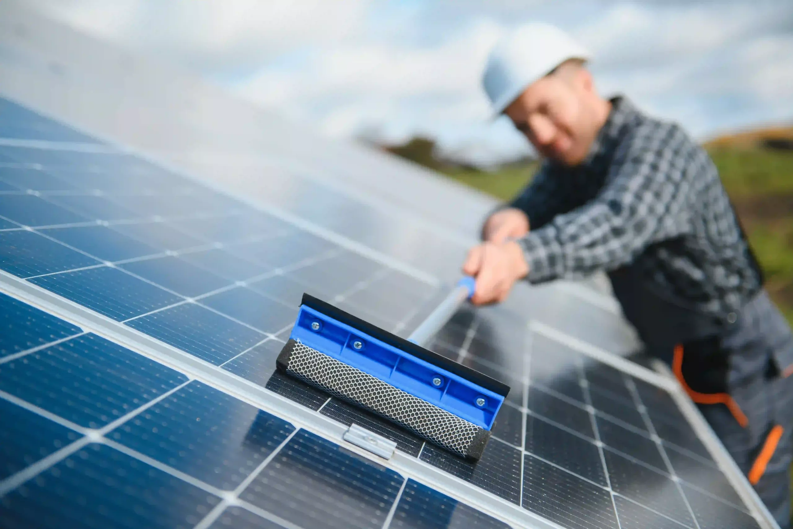 Worker Cleaning Solar Panels