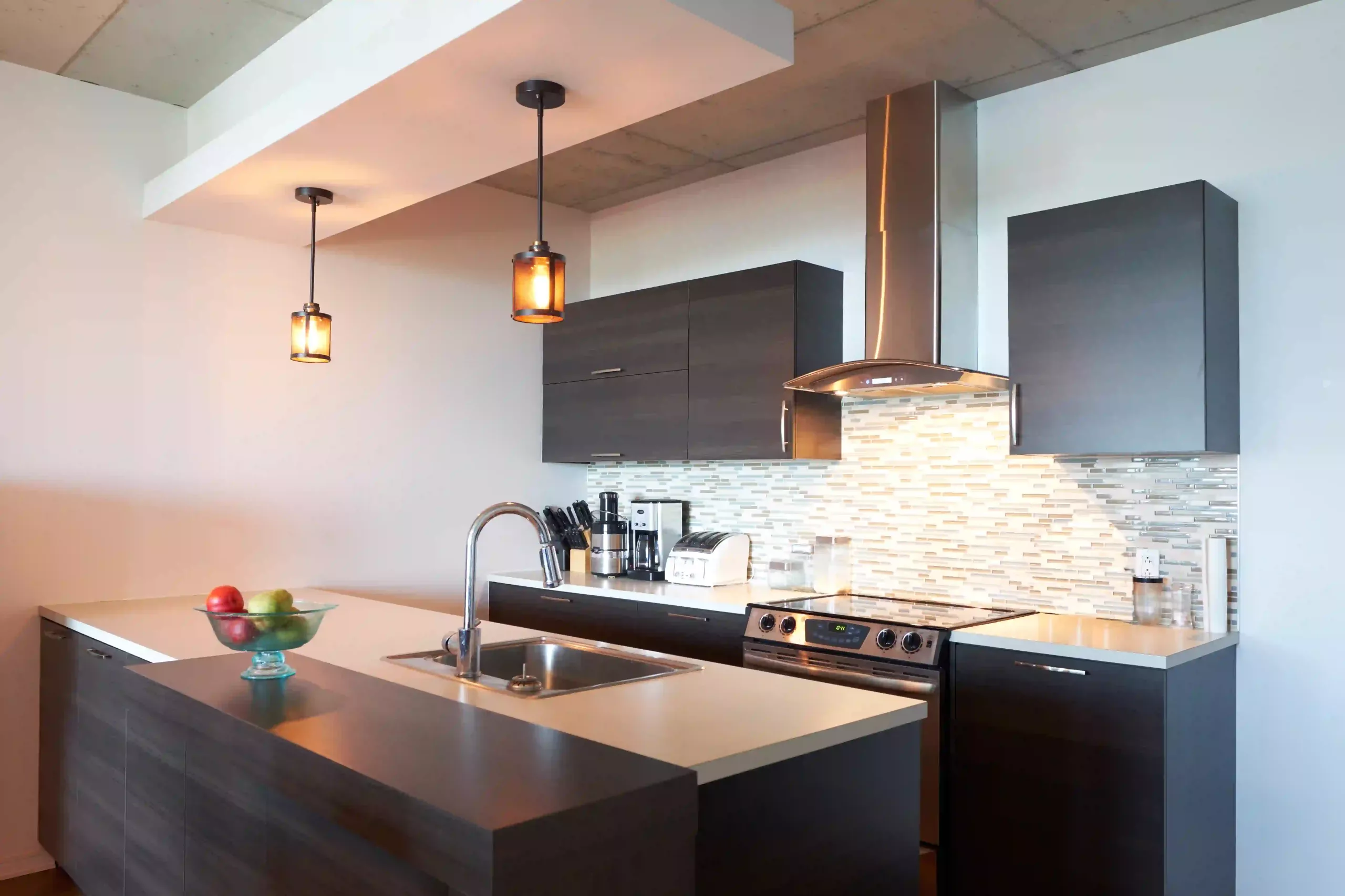 A Stylish Pendant Light Hanging Over A Modern Kitchen Island, Providing Both Task Lighting And A Focal Point.