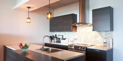 A Stylish Pendant Light Hanging Over A Modern Kitchen Island, Providing Both Task Lighting And A Focal Point.