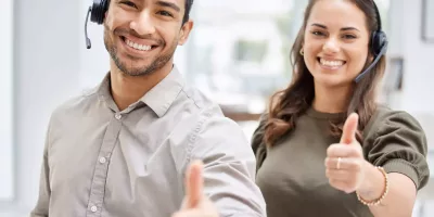 Cropped Portrait Of Two Young Call Center Agents Giving Thumbs Up While Standing In The Office,emphasizing The Manufacturer's Commitment To After Sales Support.